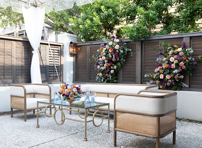 Small table with two chairs outside with candles.